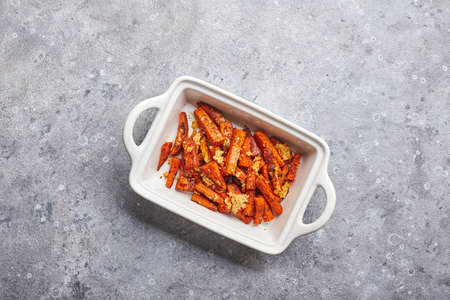 Sweet potato with cheese backed in bowl on grey backgroundの写真素材