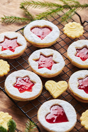 Classic Linzer Christmas Cookies with raspberry or strawberry jam on wooden tableの写真素材
