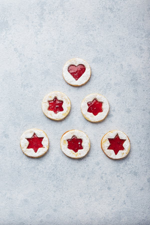 Classic Linzer Christmas Cookies with raspberry or strawberry jam on light background.の写真素材