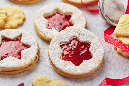 Classic Linzer Christmas Cookies with raspberry or strawberry jam on light background.