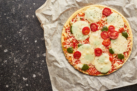 Fast food baked frozen pizza with cheese, tomatoes and pesto. Ready to eat.