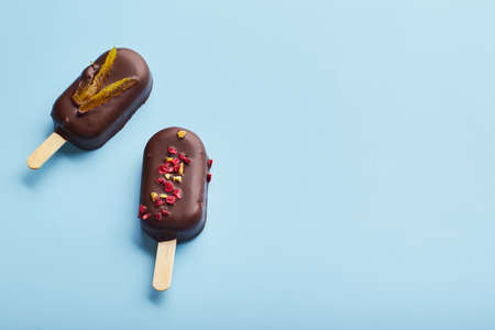 Mousse dessert with fruit flavors in the form of ice cream on blue background.の写真素材