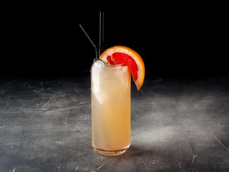 Cold alcoholic or non-alcoholic cocktail with ice on dark backgroundの写真素材