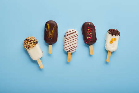 Mousse dessert with fruit flavors in the form of ice cream on blue background.の写真素材
