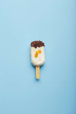 Mousse dessert with fruit flavors in the form of ice cream on blue background.の写真素材