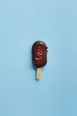 Mousse dessert with fruit flavors in the form of ice cream on blue background.の写真素材