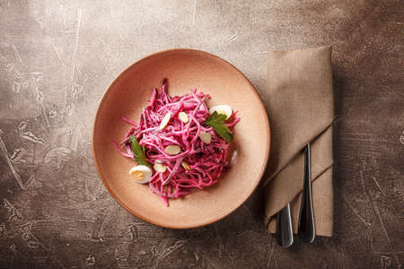Daikon and beet salad dressed with mayonnaise or yogurt, garnished with almonds and quail eggsの写真素材