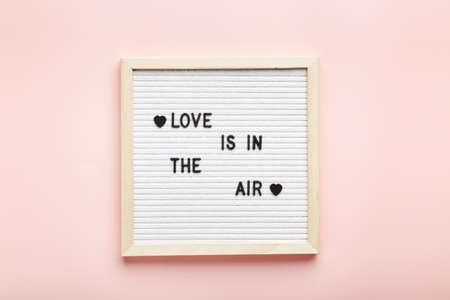Letter board on pink background. Top view. Romantic background for Valentines dayの写真素材