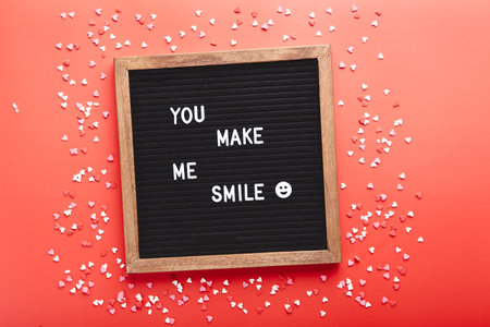Letter board with hearts on red background. Top view. Background for Valentines dayの写真素材
