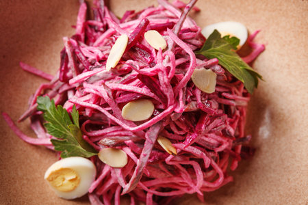 Daikon and beet salad dressed with mayonnaise or yogurt, garnished with almonds and quail eggsの写真素材