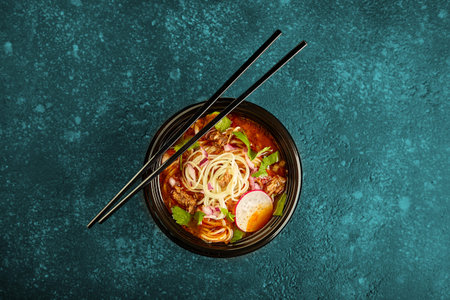 Birria ramen, consomme soup with beef and noodle. Mix of Mexican and Asian cuisine