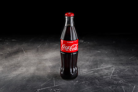 Glass bottles of Coca Cola soft drink. Global brands of carbonated soft sweet drinksのeditorial素材