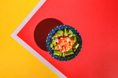Poke bowl with rice, avocado, edamame beans and smoked salmon. Hard light, deep shadow
