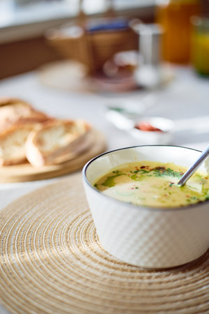 Bowl of potato soup with parsley and bacon with toasted bread croutons in white bowl. Comfort mealの写真素材