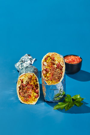 Traditional Mexican Beef Burrito with Nachos Chips and Salsa Sauce.の写真素材