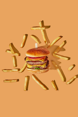 Burger and French fries scattered on the background. Top viewの写真素材