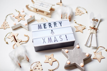 New Year or Christmas composition, flat lay, top view. Light box inscription Merry Xmas and wooden...