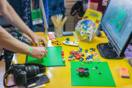 KROPIVNITSKIY, UKRAINE â 12 MAY, 2018: Stop motion animation process with Lego details and toy cars. Men's hands expose stop motion elements to create animations using a DSLR cameraのeditorial素材