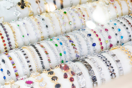 Stylish beautiful bijouterie hanging on the stand in the accessories store. Various Jewelry...
