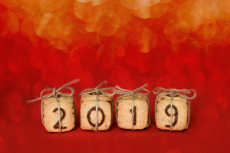 Gift festive Christmas digits 2019 made from cookies on red festive background with lights and bokeh. Delicious sweet confectionery gift Christmas card. Idea of merry new year xmas 2019 holidayの写真素材