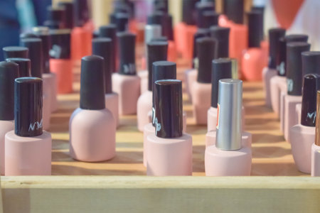 A lot of nail gel polish bottles on the shelf in the salon, shop. fashion colorful manicure nail polish bottle collection set backgroundの写真素材