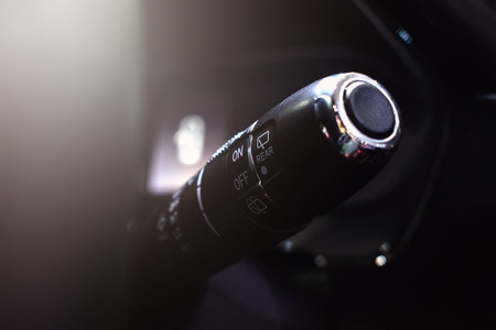 Close up car steering wheel with wipers control buttons. Car Rain Windscreen Wiper Control Stick. Adjustable wiper blade, Modern car interior detailsの写真素材