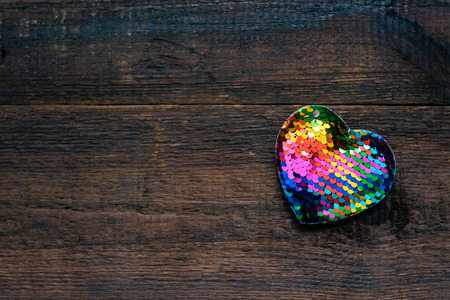 Valentines Day background, mockup with one Lgbt rainbow heart on rustic wooden background. Valentine Day, love, romance, dating concept, copy spaceの写真素材