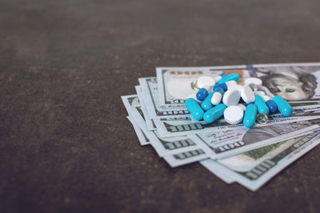 Money and pills. Various medicines and pills on background of USA dollars banknotes. Expensive...