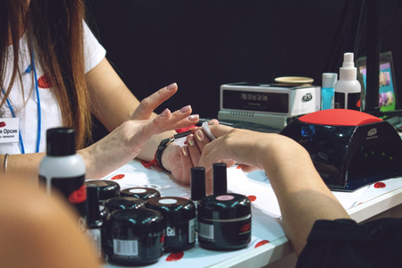 Kiev, Ukraine â 19 September, 2018: Manicure Master make gel nail extension during master-class at the beauty show.のeditorial素材