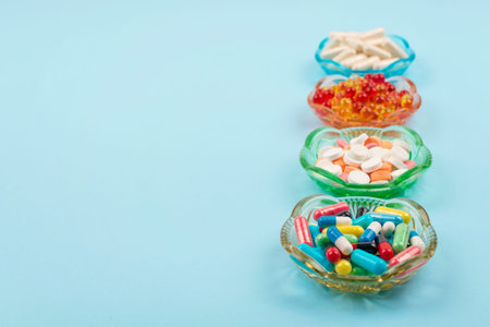 Cold medicine, health care, traditional medicine and flu concept. Various multi-colored pills and...