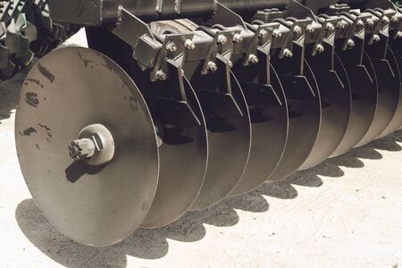 Working parts of new agricultural disc harrow. Plow. Harrow. Cultivator for cultivating the earth.の写真素材