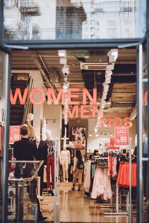 Customers in modern cloth store, shop, mall, boutique. Display in mall. Kiev, Ukraine - September 02, 2019.の写真素材
