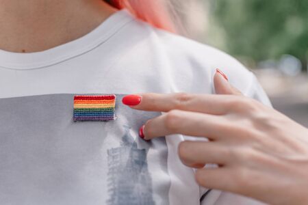 Female hand with red nails points to lgbt sign. LGBTQ, lgbt gay pride tolerance concept.の写真素材