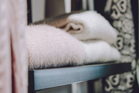 Sustainable living, Zero waste wardrobe. Secondhand fashion. Various clothes on hangers on shelves at local market, shop, store.の写真素材