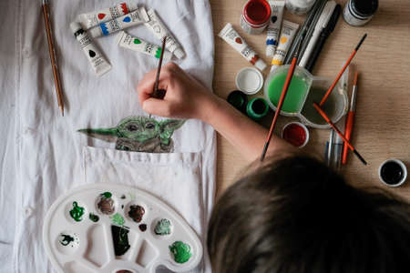 Baby Yoda from new Disney Star War TV series Mandalorian drawing on fabric with acrylic paints. Fan art. Kropivnitskiy, Ukraine, January 7, 2020.のeditorial素材