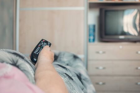 Coronavirus self-isolation advice for over-70s Elders, social isolation and loneliness in older people. Age-group risk for coronavirus. Lonely elderly woman lies in bed at home.の写真素材