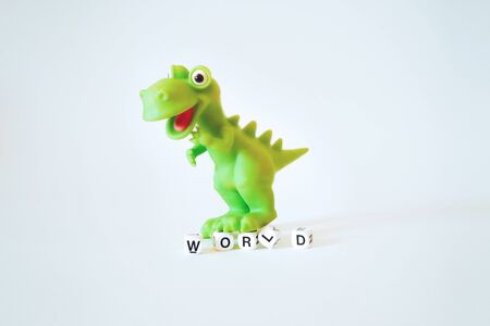 Coronavirus global economic crisis concept with toy dinosaur and word world. Shock to the global economy from Coronavirus Covid-19 pandemicの写真素材