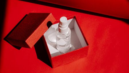 Post-Covid New Normal concept with Alcohol hand Sanitizing Spray as gift in red gift box. How Will Things Change In Post Pandemic World.の写真素材