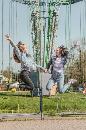 Generation Z, gen z, Homelanders, Homeland Generation, Zoomers, New Silent Generation. Two young Happy girls friends having fun in the summer park.の写真素材
