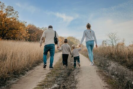 Global Day of Parents. Happy family enjoying together on a sunny day in country. father, mother and two boy children having fun and playing in natureの写真素材