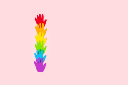 Pride, LGBT flag symbol concept with rainbow color palm hands heart butterfly shape on pink...