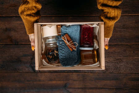 Care box, package ideas. Fall or Winter care box with sweets and warm clothes. Care Package Delivery, Fall Winter holidays Food Care gift boxの写真素材