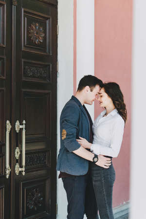 Couple in love. Valentines day celebration, love and dating outdoor concept. Happy loving couple walking on the city street, hugging and kissingの写真素材