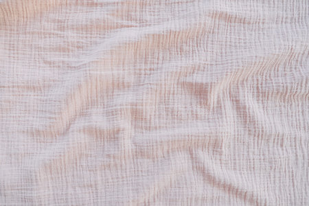 Muslin cloth texture background in neutral tones. Muslin cotton fabric of plain weave. Muslin is a...