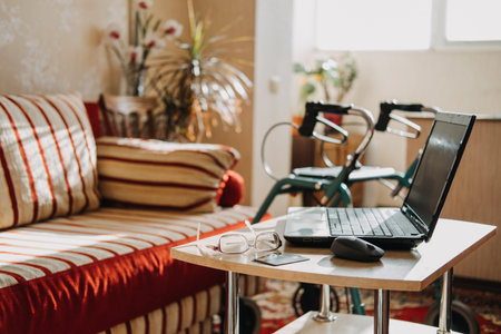Disability Support Pension Life Insurance, Disability medical insurance policy for Seniors. Laptop, glasses and documents on the background of Rollator Mobility Walker for Seniors at home.の写真素材