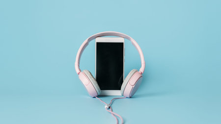 Headphones and smartphone on blue background. Audio voice Social network, invitation-only audio chat...
