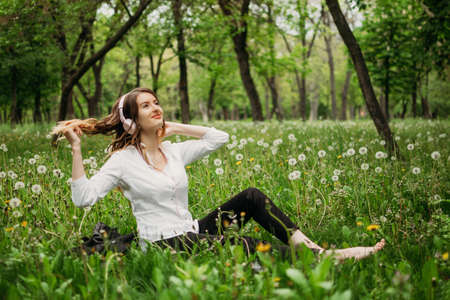 Work life balance, Essentials of Wellbeing, harmony between work and personal life. Young business women in formal suit enjoying the nature in public parkの写真素材