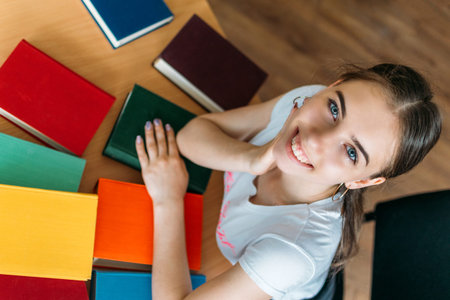 Back to school, reading book, education, library concept. Student girl with book on background of...