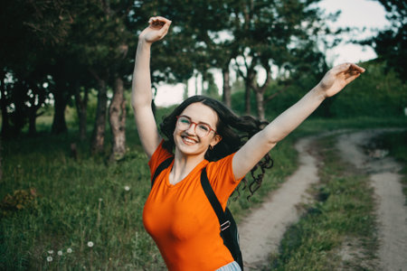 Summer vacation, school College break in summer, students get time off, Academic year end. Young brunette teen girl with backpack and colorful balloons enjoying the summerの写真素材