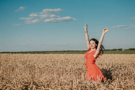Focus on Yourself, Motivation and inspiration, rethink everything, freedom, . Happy young girl enjoying life in the wheat field on sun summer dayの写真素材